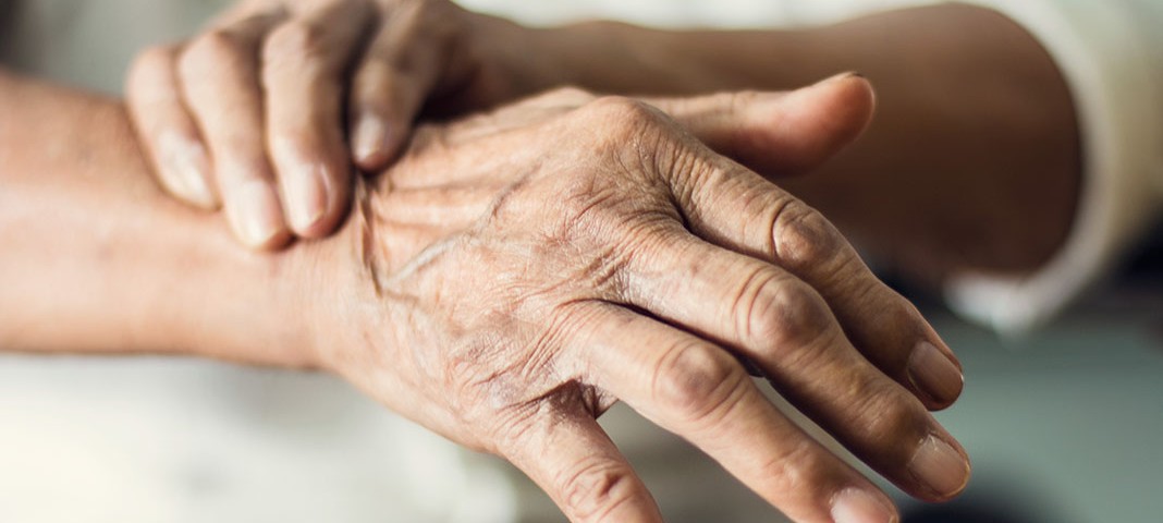 Close up hands of senior elderly woman patient suffering from pakinson's desease symptom. Mental health and elderly care concept