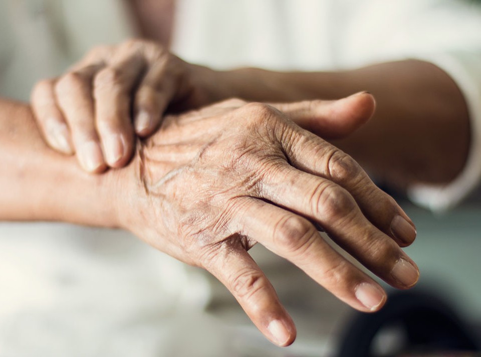 Close up hands of senior elderly woman patient suffering from pakinson's desease symptom. Mental health and elderly care concept